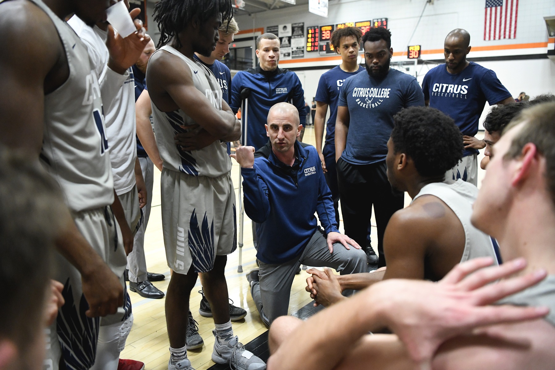 Head Coach Brett Lauer breaks things down for for his squad in the timeout huddle. Image: Mike Baker
