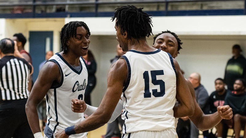 Chris Chiles and Anthony Tello celebrate with Uriah Foster, who finished with 20 points for the Owls. Photo by Jacob Bramley