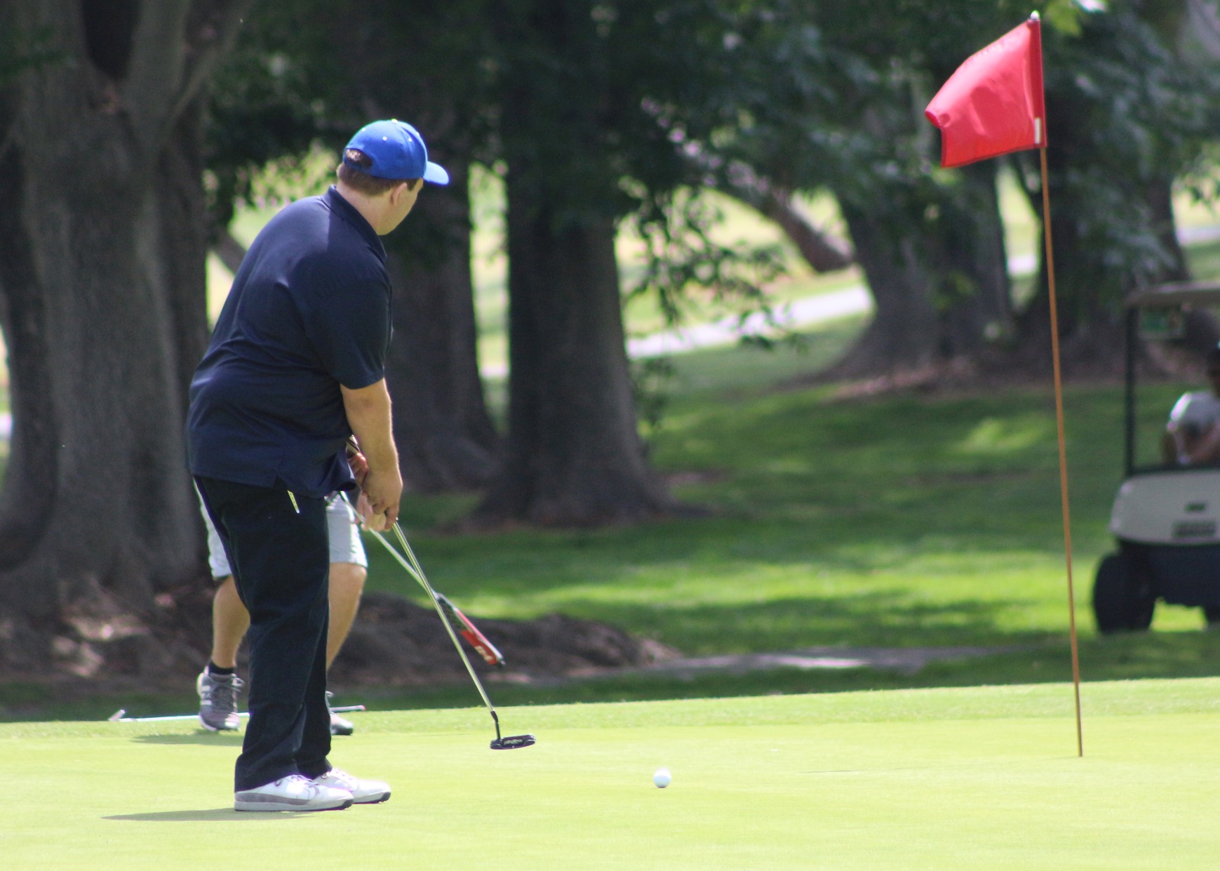 Brandon Martin watches his putt on the 5th green.