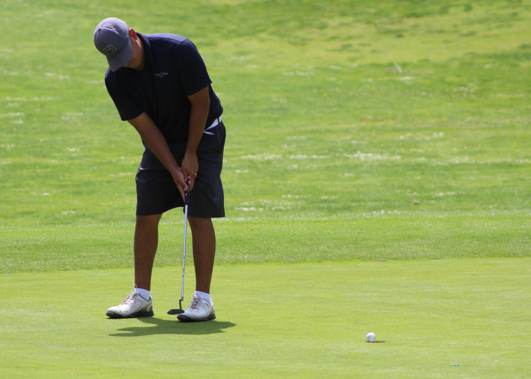 Michael Duran sinks a putt on the 5th green.
