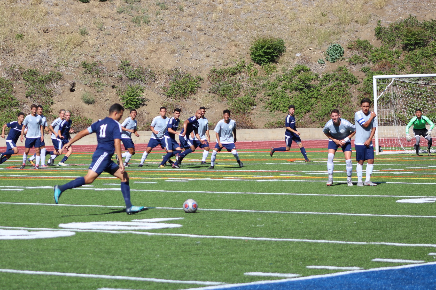 Edgar Guadalupe-Garcia takes a free kick as his teammates prepare. Image: Molly Montell