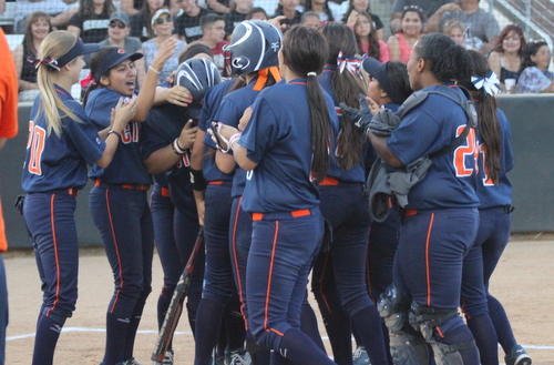 The Owls celebrate sophomore Sara Moore's leaf-off home run from Saturday evening.