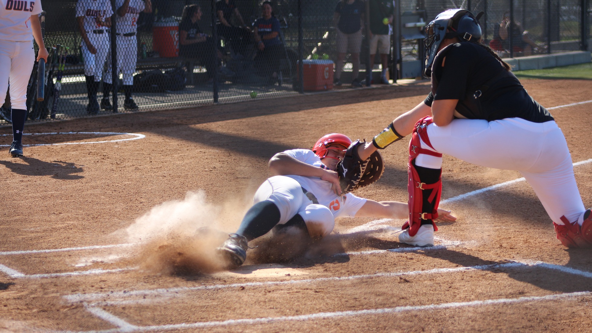 Hailee Reinert avoids the tag to score for the Owls. Photo by: Brianna Jara