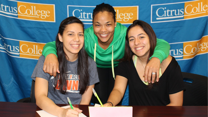 Sophomores Elsie Mejia (left) and Natalie Gutierrez (right) sign their scholarship offers with Head Coach Linnae Barber Matthews (center).