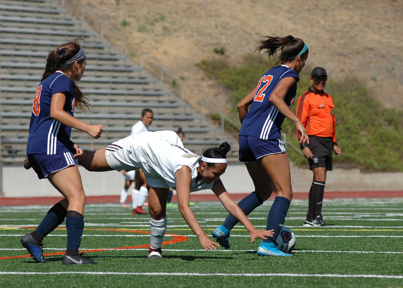 Zeanna Silva(12) and Brianna Jara(18) team up to steal the ball. Image: Thomas Garcia