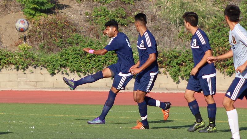 Sophomore Bryan Canchola (#4) works to clear a ball for the Owls during Tuesday evening's loss to College of the Canyons.