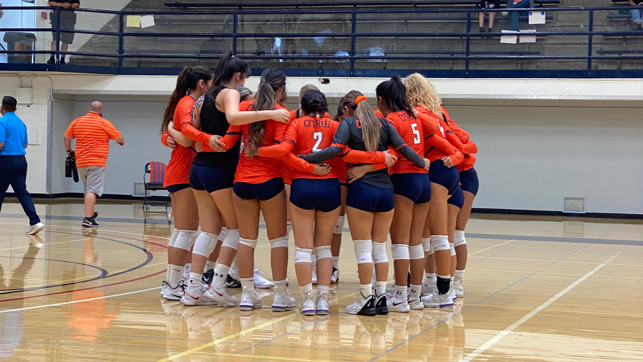 The Citrus College volleyball team huddles up.